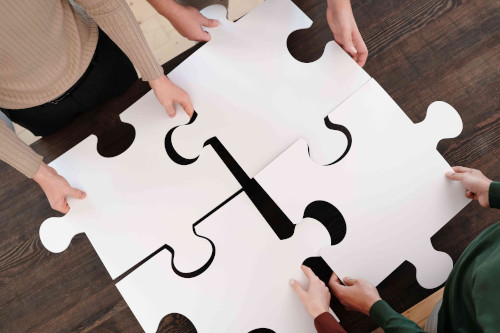 Hands connecting puzzle pieces